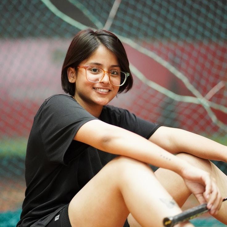 Aisha Noor, Lead Design Curator at Harvest Grove Way, reviewing corporate floral arrangements